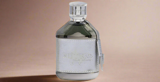 Warm amber-citrus gradient with subtle spice swirl, ghosted orange-blossom petals, and soft gloss floor—background designed for Nitro Elixir by Dumont Paris (1080×1080)